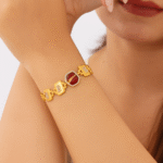 regal gold bracelet with ruby red centerpiece