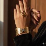 regal gold bracelet combo with blue solitaire accent